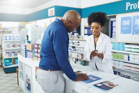 Make sure your customers are aware of the side effects. a female pharmacist Stock Photos