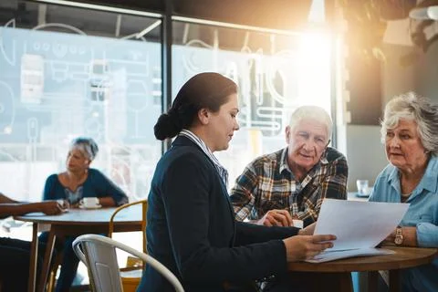Make sure your money is protected. a senior couple meeting up with a financial Stock Photos