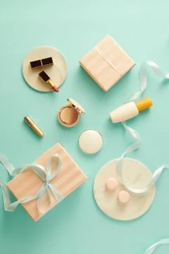 Make up table with foundation, blush, brushes, lipstick and giftbox indoors Foto stock