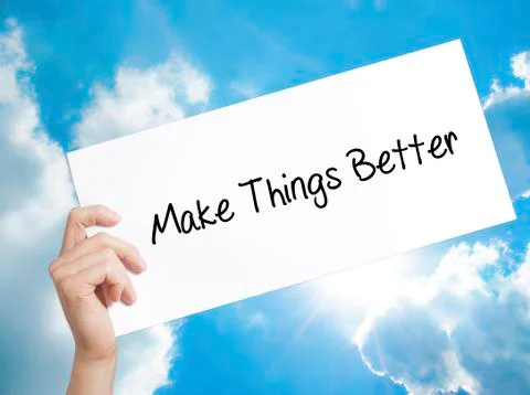 Make Things Better Sign on white paper. Man Hand Holding Paper with text. I.. Stock Photos
