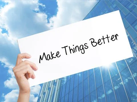 Make Things Better Sign on white paper. Man Hand Holding Paper with text. Iso Stock Photos