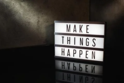 Make things happen motivational message on a light box Stock Photos