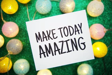 Make Today Amazing text on paper card with LED cotton balls decoration on gre Stock Photos