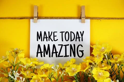 Make Today Amazing text on paper card with flower blooming decoration on ye.. Stockfoto's