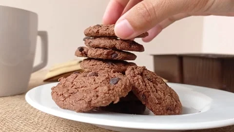 Make a tower of chocolate biscuit on a white plate Stock Footage 150399002
