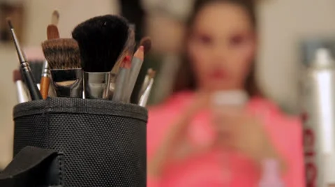 Make up of unknown woman with make up brushes in foreground Stock Footage 25607431