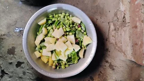 To make vegetable by cutting potato sim in a bowl and eating it Stock Photos