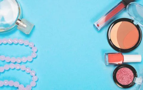 Make up woman essentials on blue background, Top view Stock Photos