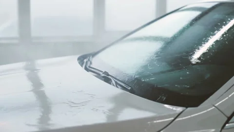 Make worker washing front bumper of white car under high pressure water after Stock Footage 129303647