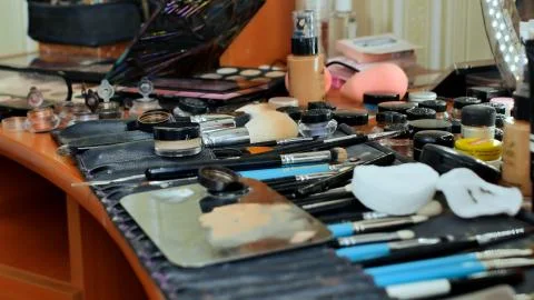 The make-up worker's desk. Many cosmetics are scattered on the table. The make Stock Photos