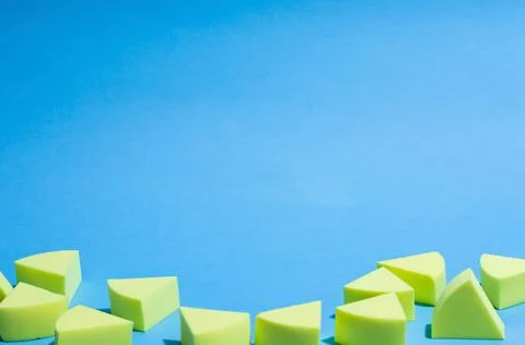 Make-up yellow sponges on a blue background Stock Photos