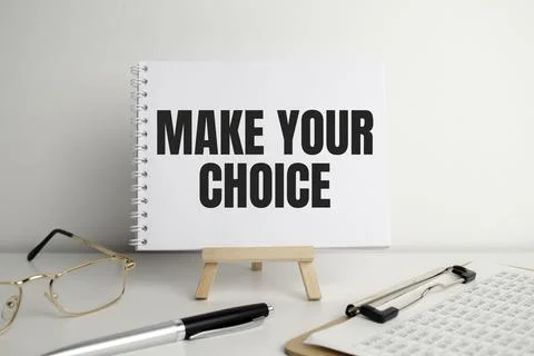 Make your choice words on paper notepad and pen on white desk Stock Photos