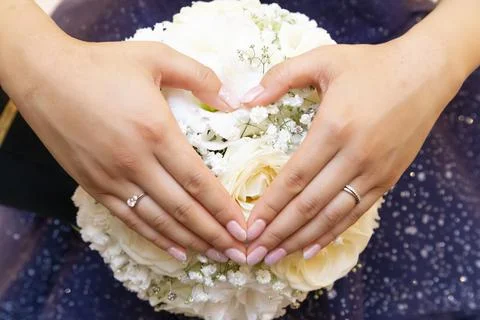 Make your hands heart-shaped on the bouquet Stock Photos