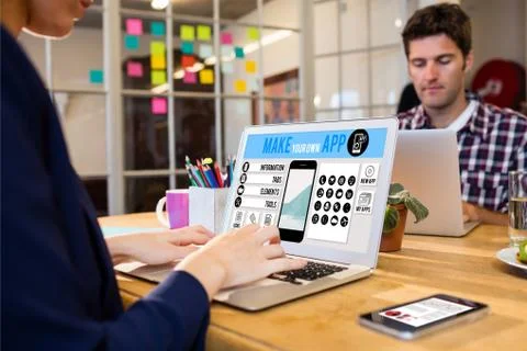 Make your own app smartphone against business people working at computer desk 스톡 사진