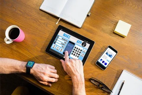 Make your own app smartphone against businessman using a tablet computer Stock Photos