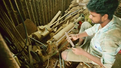 Maker grind tool edge with spinning disk in workshop Stock Footage 314177473