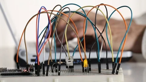 Maker, student or electronics engineer programming microchip prototype electr Stock Footage 102145121