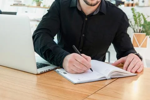 Makes appointment notes, writes important things and to-do list. Concentrated Stock Photos