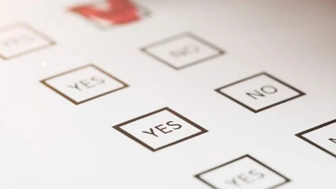 Makes a choice by marking answer yes or no on the voting ballot application form Stock Footage 204794110
