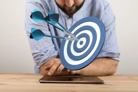 A  makes a dart throw on the target. The concept of persistence in business.. Stock Photos