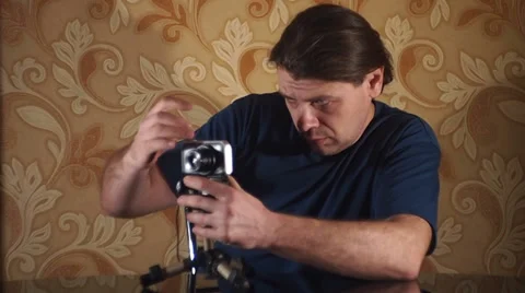 Makes a picture with a compact digital camera and a small tripod Stock Footage 35720294