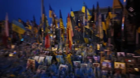 Makeshift memorial for fallen soldiers with flags and photos on Maidan in Kyi Stock-Footage 303626928