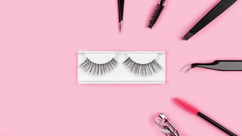 Makeup accessories. Fake eyelashes. Tools for extensions on pink background. Stock Footage 159902738