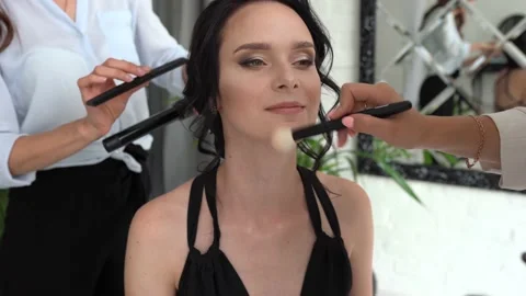 Makeup and hairstyle process with beautiful young woman in modern interior room Stock Footage 154367202