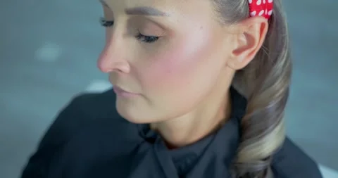 Makeup Application on Woman with Red Polka Dot Headband Stock Footage 323496605