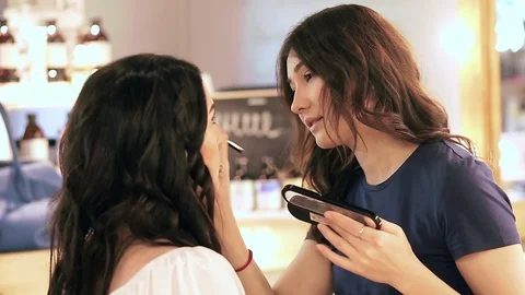 Makeup artist and a client chat during the session Video stock 76085969