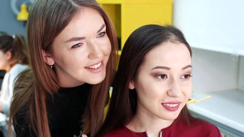 Makeup artist and model looking in mirror and smiling in beauty Studio. Stock Footage 103386317