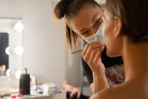 Makeup artist and model in salon Stock Photos