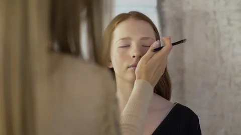 Makeup artist applies corrective shadows on the eyelids Stock Footage 99482234