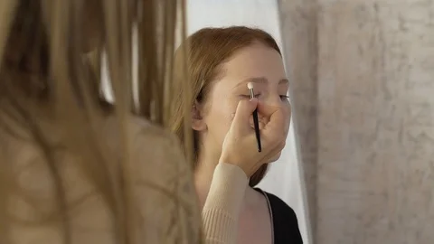 Makeup artist applies corrective shadows on the eyelids Stock Footage 99482255