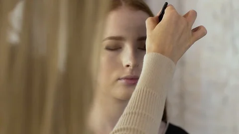 Makeup artist applies corrective shadows on the eyelids Stock Footage 99482270