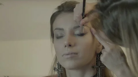 Makeup artist applies eye shadow. Beautiful woman face. Perfect makeup Stock Footage 67962068