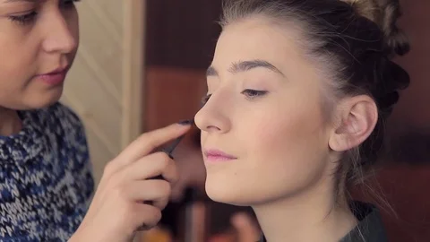 Makeup artist apply makeup on model brow Stock Footage 72602024