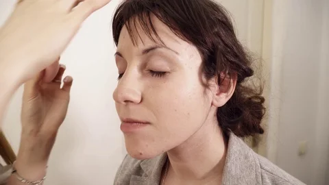 Makeup artist applying base to the face Video stock 75381608