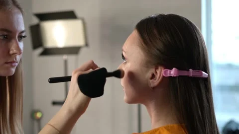 Makeup Artist Applying Blush on Womans Cheek Stock Footage 309622039