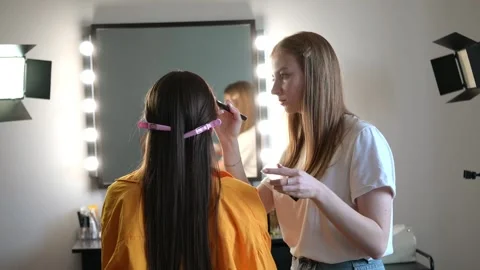 Makeup Artist Applying Eye Makeup in Professional Studio Stock Footage 309621976