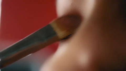 Makeup artist applying eye shadow on a woman Stock Footage 275329919