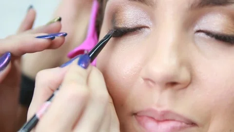 Makeup artist applying eyeshadow. Stock Footage 81572455