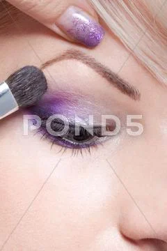 Makeup artist applying eyeshadow Stock Photos