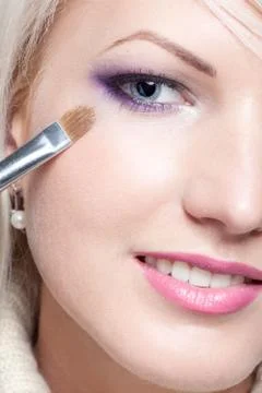 Makeup artist applying eyeshadow Stock Photos
