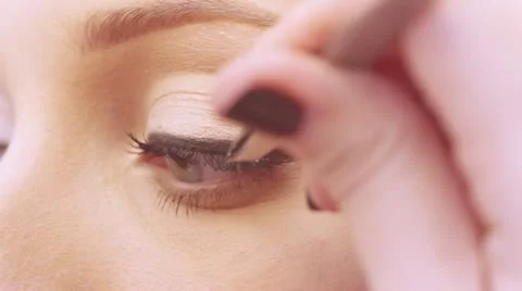 Makeup artist applying false eyelashes to model's eyes. Stock Footage 21125615