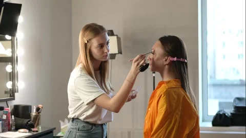 Makeup Artist Applying Foundation to Client in Salon Stock Footage 309622007