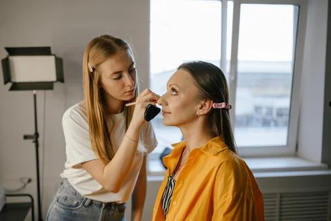 Makeup Artist Applying Foundation to Client in Salon Stock Photos