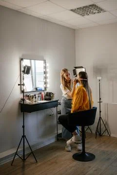 Makeup Artist Applying Foundation to Client in Salon Stock Photos
