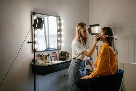 Makeup Artist Applying Foundation to Client in Salon Stock Photos