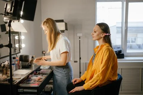 Makeup Artist Applying Foundation to Client in Salon Stock Photos